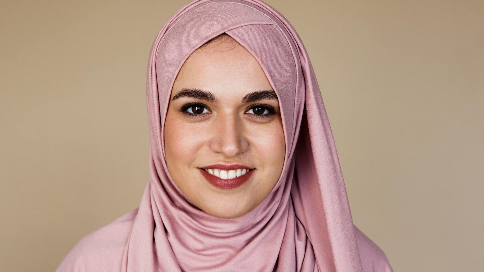 woman in pink hijab smiling