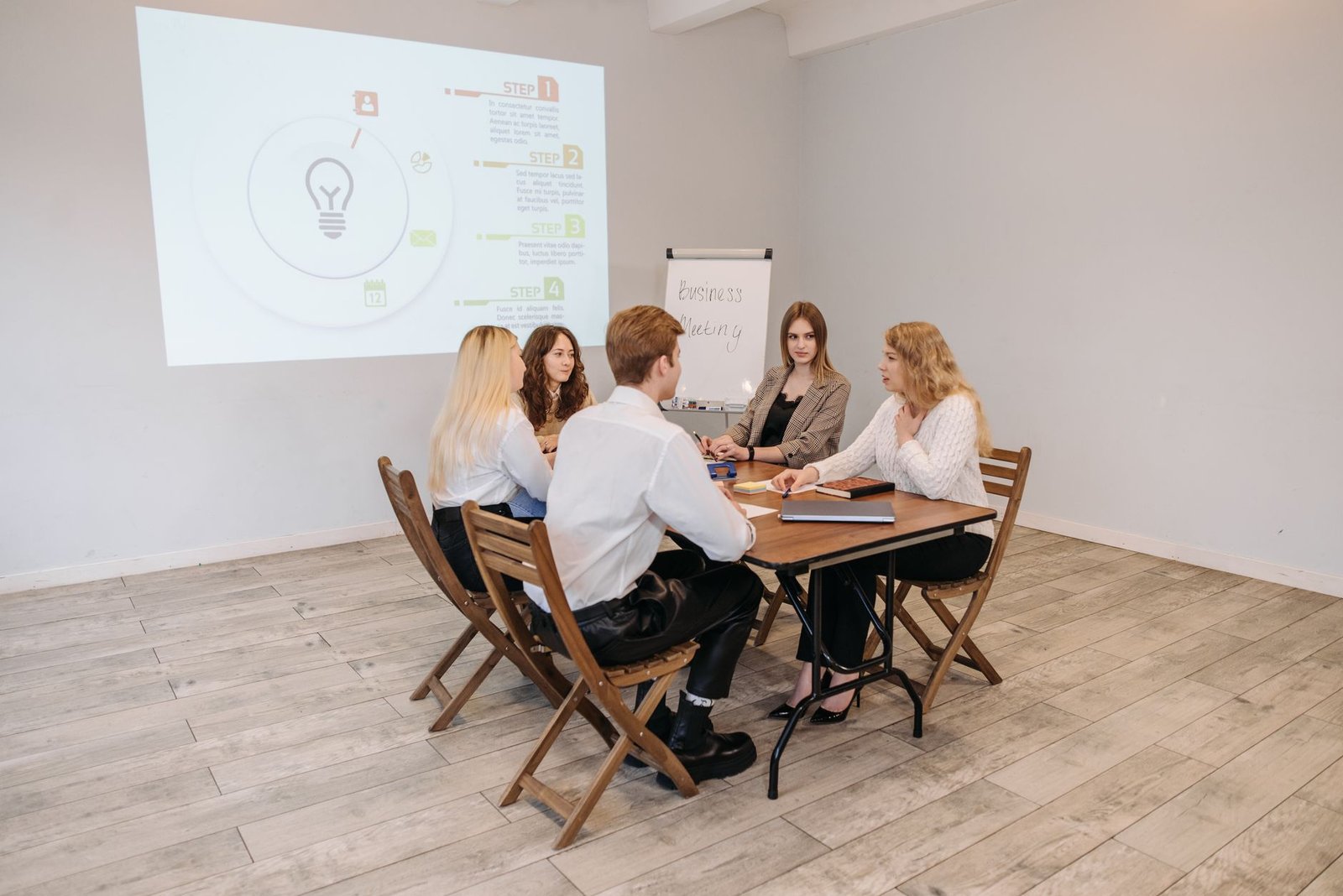 a group of people at a wooden table in a meeting